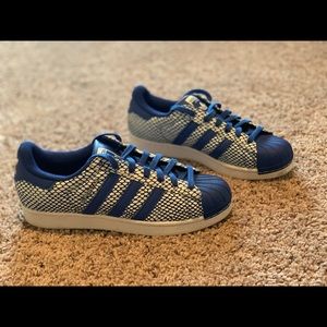 Blue and white shell toe adidas